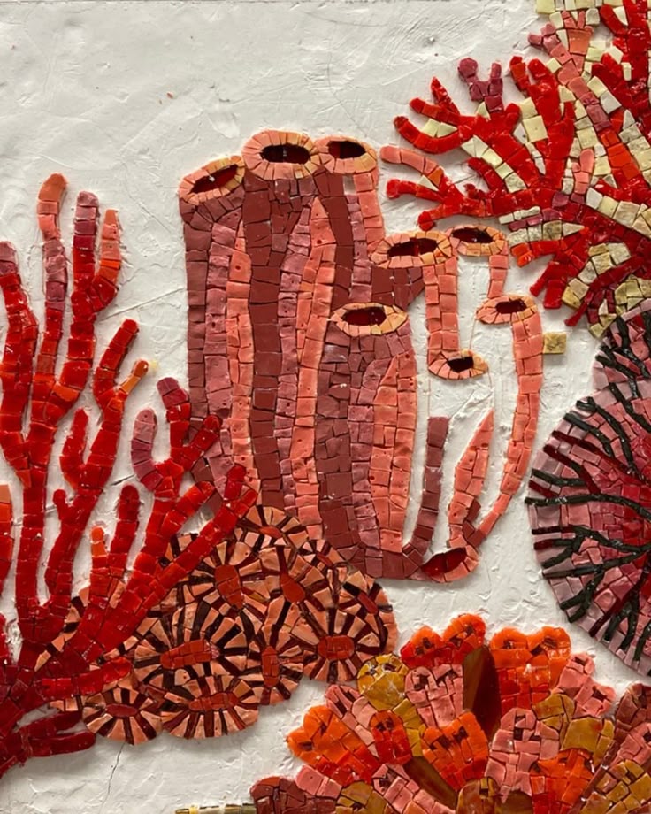 Red coral mosaic on white plaster